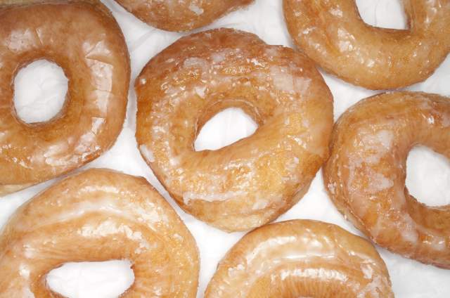 Patrons line up each morning for warm glazed yeast donuts at cash-only Longs Bakery