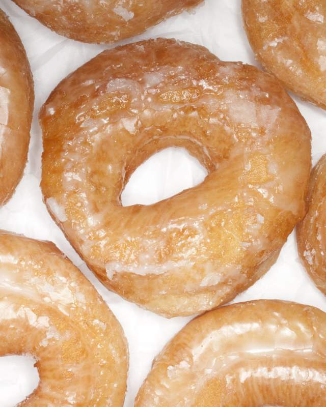 Patrons line up each morning for warm glazed yeast donuts at cash-only Longs Bakery