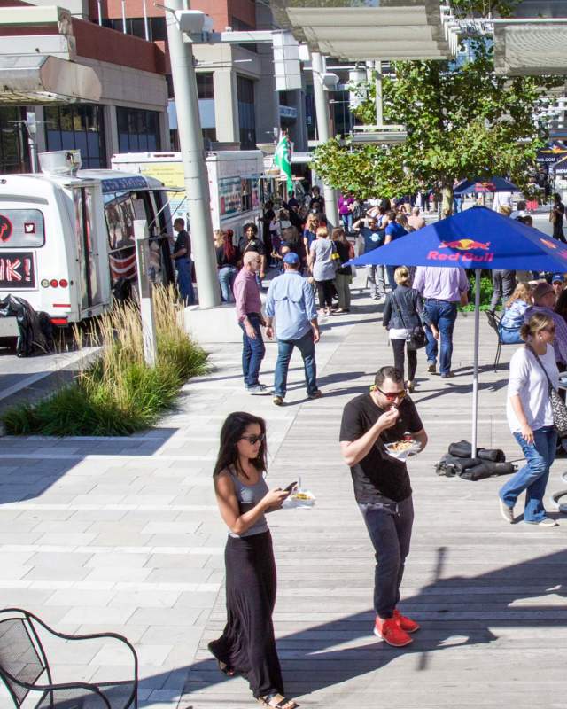 Hungry visitors enjoying food trucks on Georgia Street