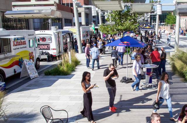 Hungry visitors enjoying food trucks on Georgia Street