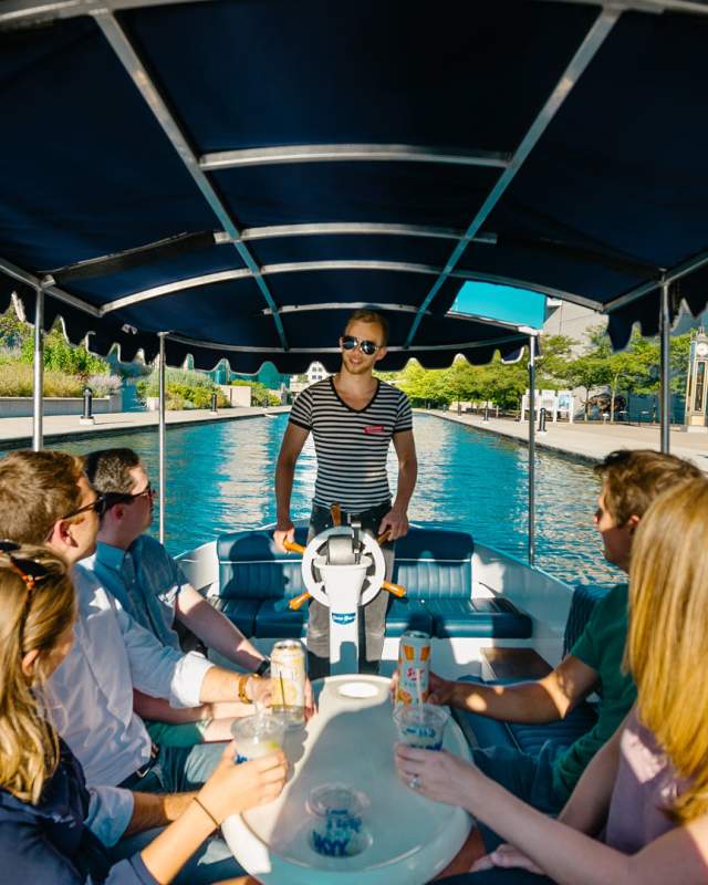 Visitors enjoy a guided cocktail cruise on the Central Canal