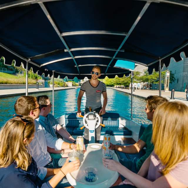 Visitors enjoy a guided cocktail cruise on the Central Canal