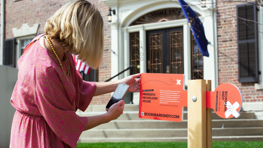 Woman with phone using Bookmark Indy